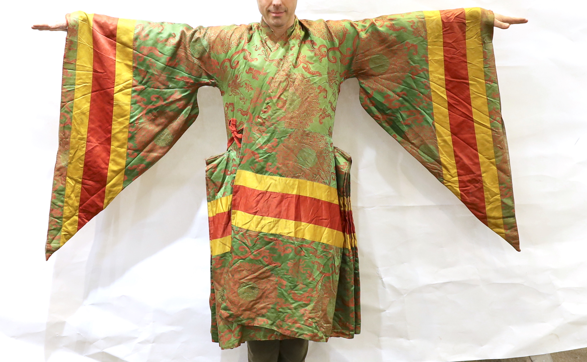 An unusual early 20th century Japanese silk damask kimono, designed with pointed sleeves and wide pleating on the hips, and horizontal yellow and red stripes, possibly a costume for a Kabuki theatre character